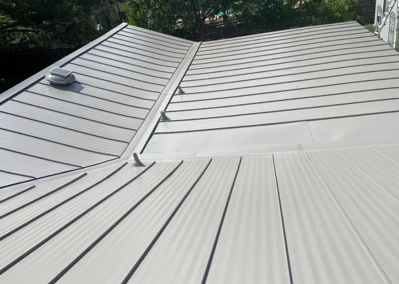 Solar attic fan installed on a metal roof for Roof Ventilation in Rockland